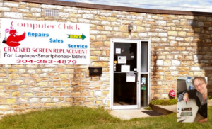 Computer Chick old Beckley, WV storefront showing a stone building with a large Computer Chick sign on the side and a glass door with a lawn in front